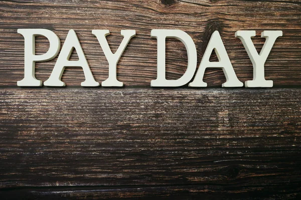Pay Day alphabet letters on wooden background