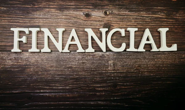木製の背景の財務アルファベット — ストック写真