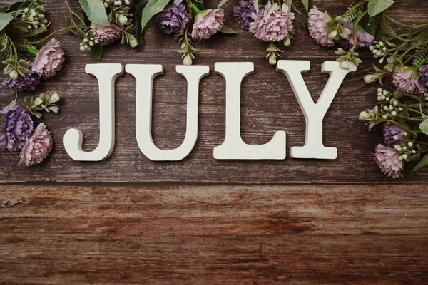 July Alphabet Letters Flower Decoration Wooden Background — Stock Photo, Image