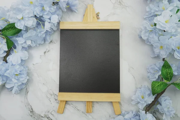 Empty Easel Space copy for text with Blooming flowers on marble background