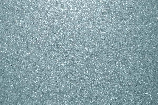 Abstract silver glitter texture background. Glittering silver grain or shining particles with sparkling light effect background for Christmas modern trendy design template