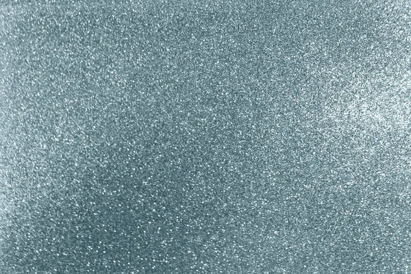 Fondo de textura de brillo plateado con efecto de luz borrosa y partículas brillantes brillantes. Brillante plata o brillante luz de nieve para la moderna plantilla de diseño de fondo de Navidad festivo de moda —  Fotos de Stock