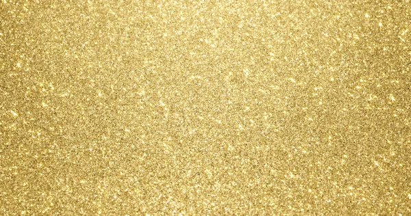 Fondo de brillo dorado con textura brillante. Luz brillante dorada, estrellas lentejuelas chispas y resplandor brillante papel de fondo — Foto de Stock