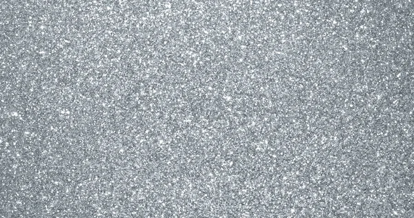 Gümüş parıltılı arka plan, ışıldayan parçacık dokusu. Gümüş ışık kıvılcımlar ve pırıl pırıl folyo pullar, parlak kıvılcımlar saçar.