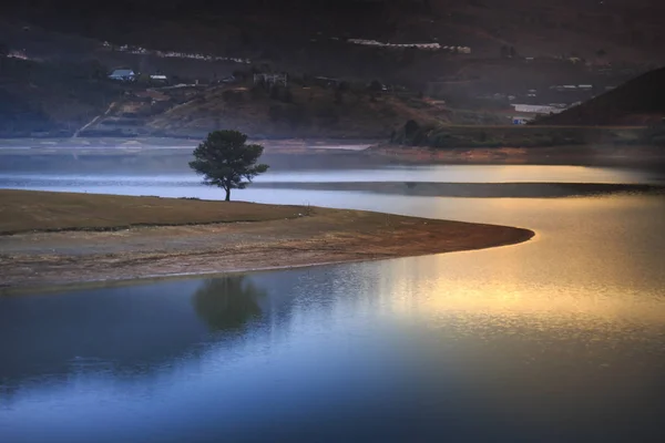 On the lake surface  reflected the first rays of dawn in the high mountains of Dalat, Vietnam