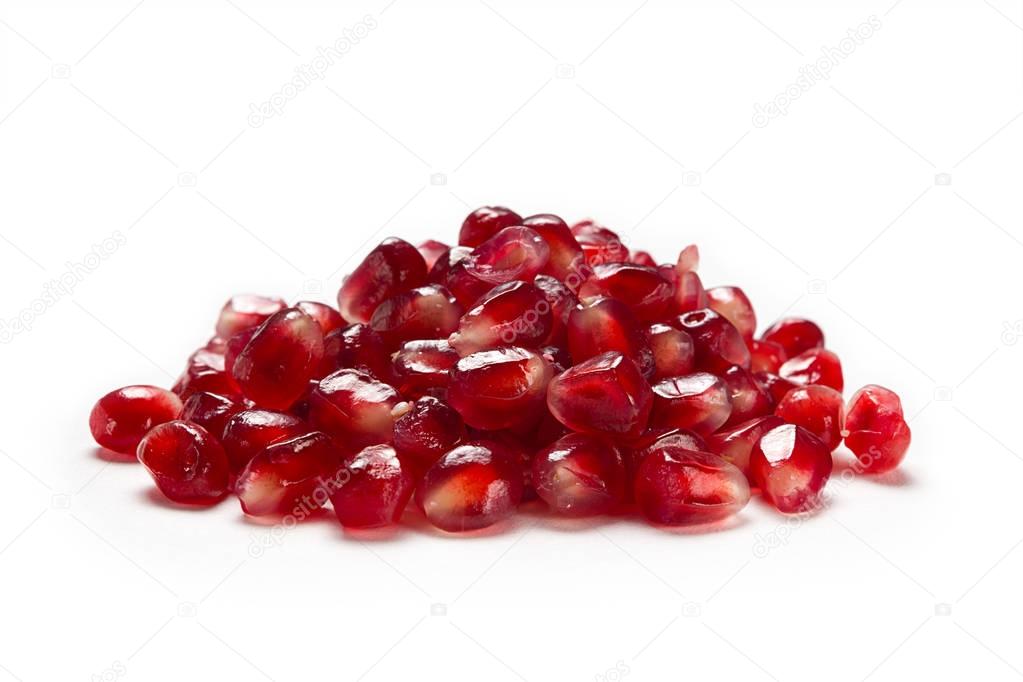 Fruit pomegranate seeds isolated on a white background side view closeup.