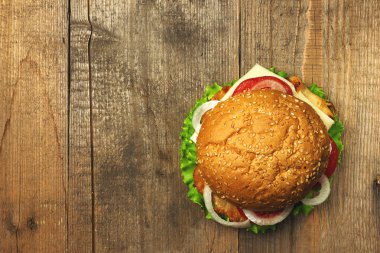 Üstten Görünüm gurme hamburger ahşap arka plan üzerinde. Fastfood yemek. Tonda vintage