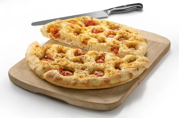 Apulian flat bread with tomatoes and knife — Stock Photo, Image
