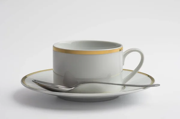 Coupe et soucoupe pour le thé décoré avec du fil d'or et cuillère — Photo