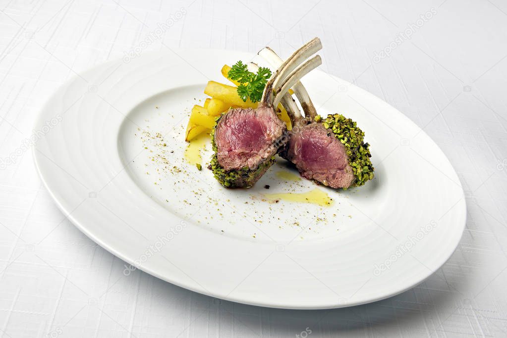 Lamb rack in crust of pistachios and French fries
