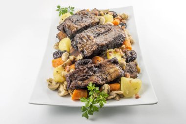 Üç pişmiş biftek kaburga mantar ca ile beyaz dikdörtgen plaka