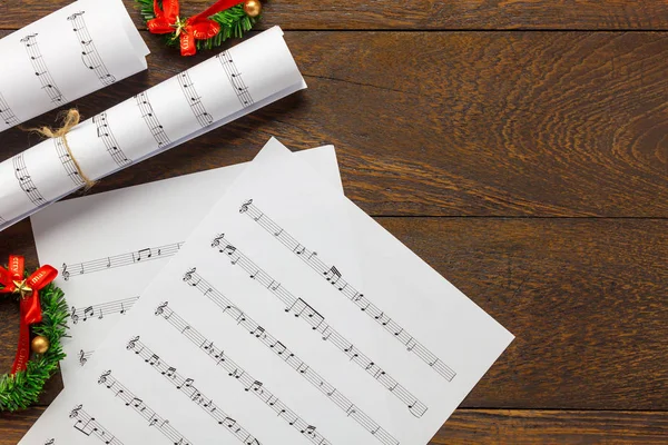 Top view Christmas music note paper  with Christmas decoration.