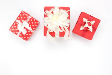 Yükü aksesuarları mutlu yeni yıl veya günün kutlu olsun ya da neşeli Noel kavramı. Yan kırmızı hediye kutusu ev masa stüdyoda modern beyaz zemin üzerine karıştırın. Alan yaratıcı tasarım yazı tipi veya metin kopyalama.