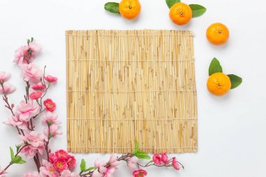Düz ay tatil aksesuar Hava resim koymak ve Çin yeni yıl tatili kavramı arka plan. Bambu döşeme alanı sahte için yukarı ve şablon. Üstten Görünüm portakal ve Ofis Masası, ahşap beyaz çiçek.
