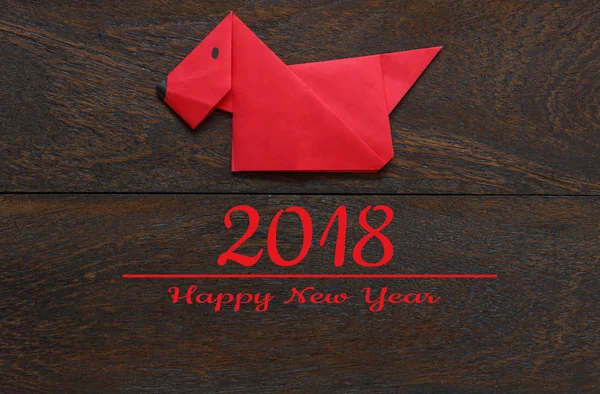 Top view shot of arrangement decoration Chinese new year & lunar holiday background concept.Flat lay of red dog paper craft by handmade on modern brown wooden at home desk.Text for 2018 design season.