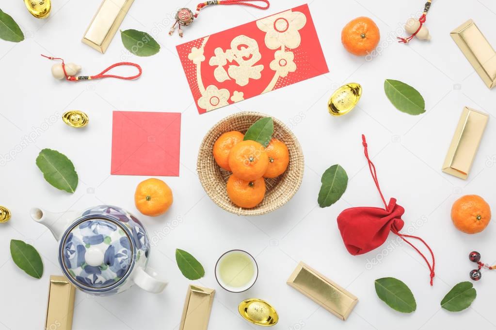 Top view aerial image shot of arrangement decoration Chinese new year & lunar new year holiday background concept.Flat lay fresh orange with food & drink on modern white wooden at home office desk.