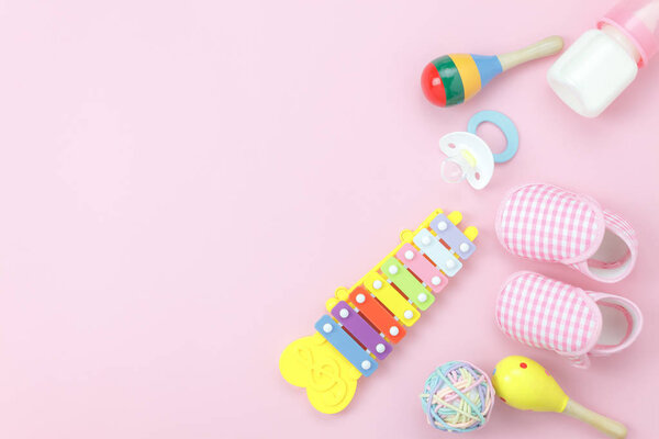 Table top view kids toys for develop background concept.Flat lay object the colorful wooden ball & percussion musical instruments on modern paper pink at office desk.Design pastel tone with copy space