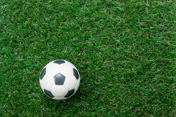 Table top view aerial of soccer or football world cup season background.Flat lay objects football on the artificial green grass wallpaper.Free space for creative design text and wording content.