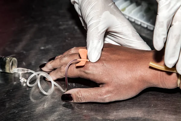 Háp orvos használata fecskendő injekciót a beteg kezét — Stock Fotó