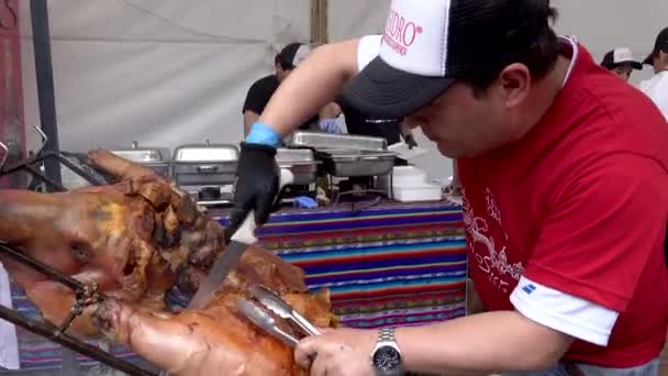 Cuenca, Ecuador - 2019-11-02 - Cuenca Days Street Fair - Свинина отрезана от всей жареной свиньи — стоковое видео