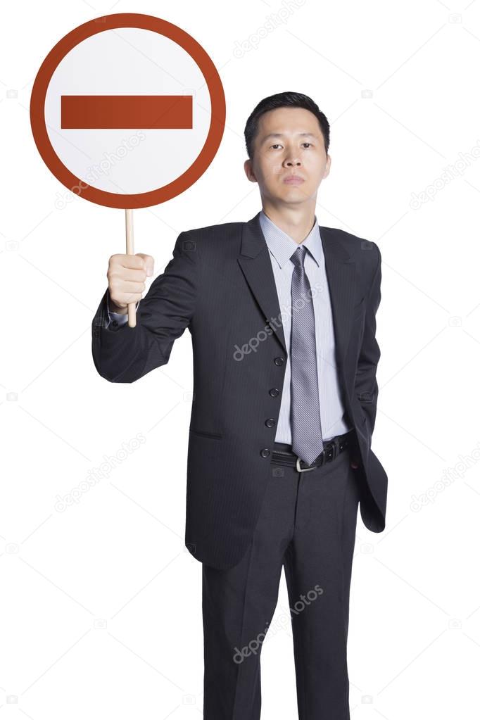 Businessman holding no entry sign