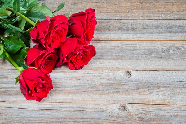 Beautiful red roses on wooden background Stock Picture