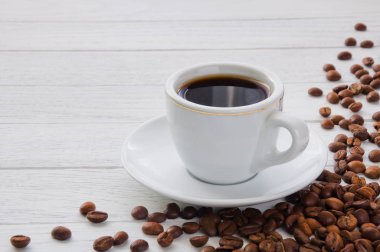 Beyaz ahşap masada bir fincan kahve.