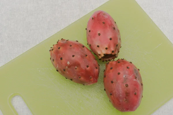 Three read  prickly pears on the white bakcgrounds. — Stock Photo, Image