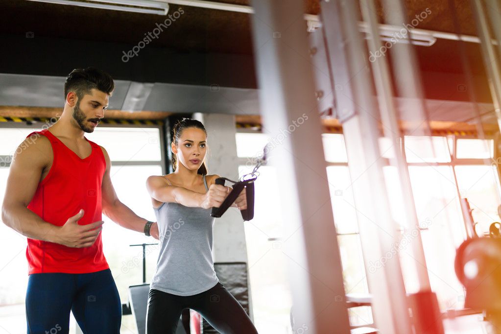 Personal trainer giving instructions in gym 