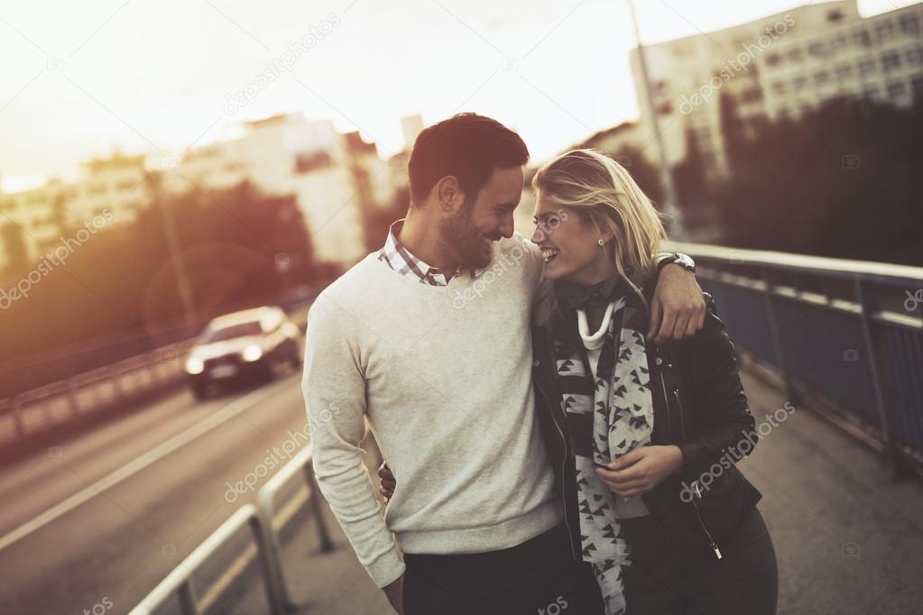Couple kissing and dating on bridge