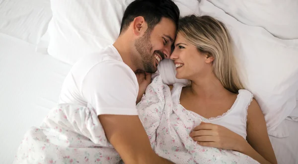 Romantic couple in bed in nightwear — Stock Photo, Image