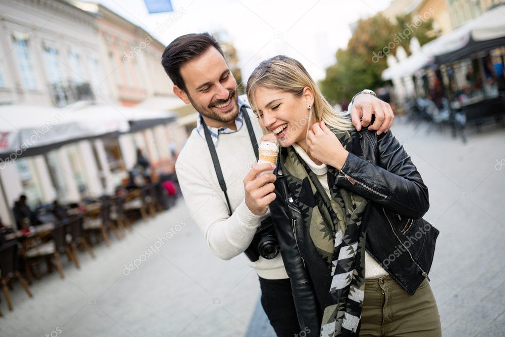 Couple sharing ice cream outdoors
