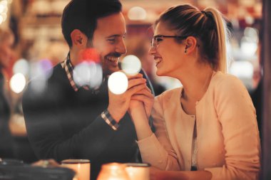 Couple dating at night in pub clipart