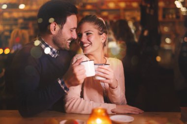 Couple dating at night in pub