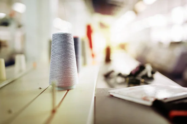 Wool and thread spools on desk — Stock Photo, Image