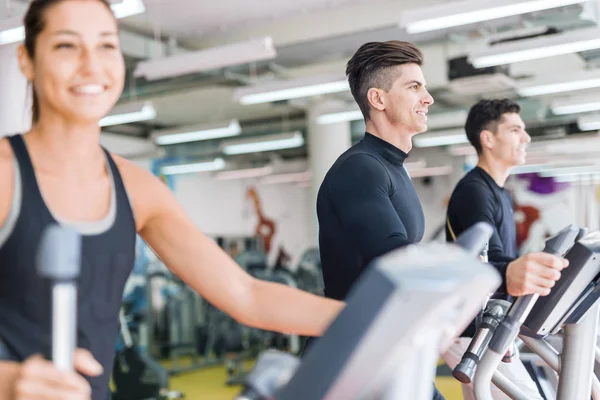 man and woman using stepper