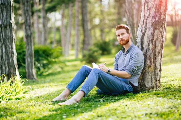 College student studying in park — Stock Photo, Image