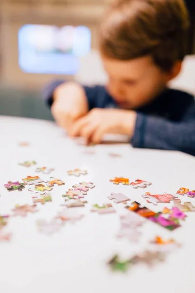 2 year old child solving jigsaw puzzle — Stock Photo, Image