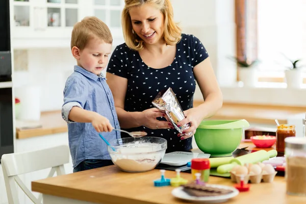 Mãe e criança preparando muffins — Fotografia de Stock