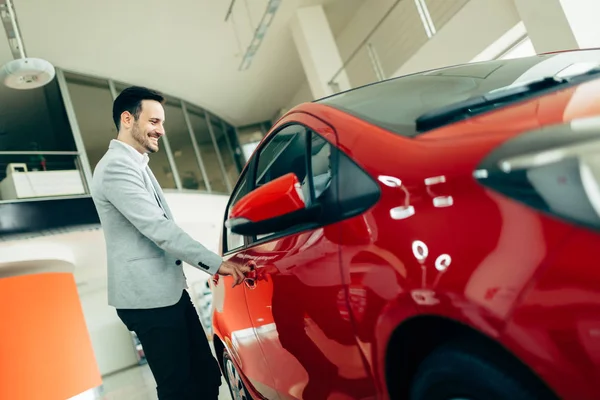 Handsome customer buying car — Stock Photo, Image