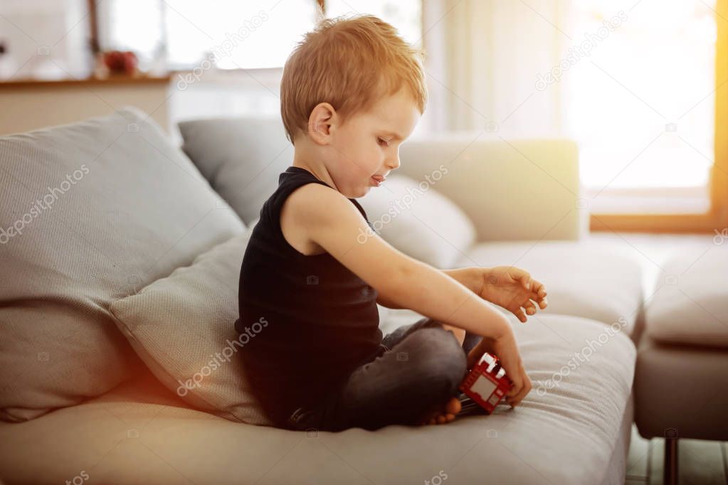 Beautiful toddler playing with his toy