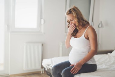 Pregnant woman with nausea in morning