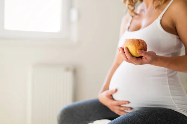 Gravid kvinna äter äpple — Stockfoto