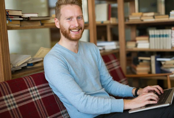 Cheerful student studying for university