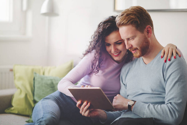 Couple hugging and smiling at home