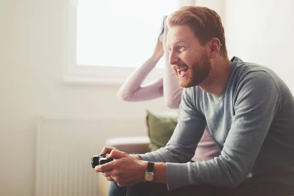 Beautiful couple playing video games on console — Stock Photo, Image