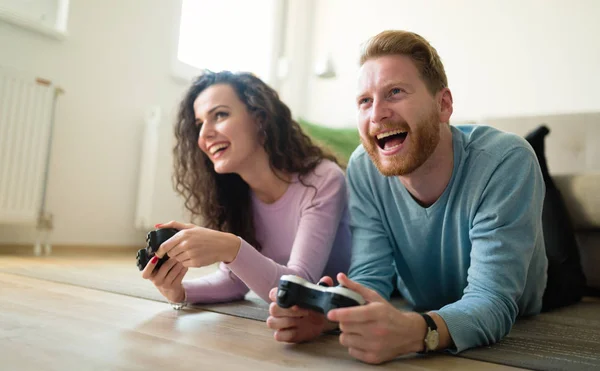 Beautiful couple playing video games on console