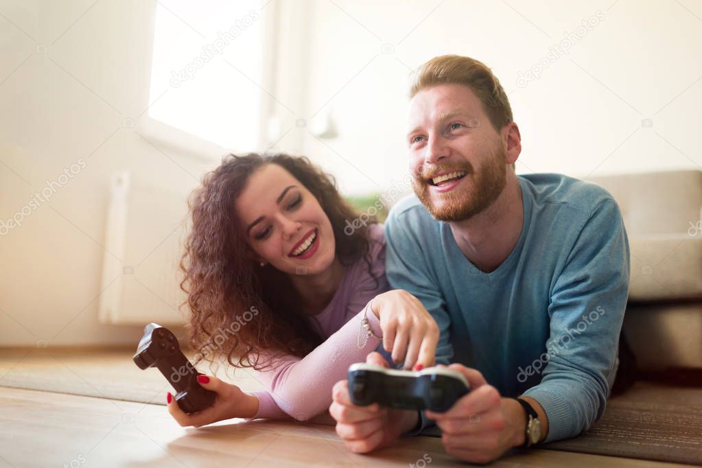 Happy couple playing video games