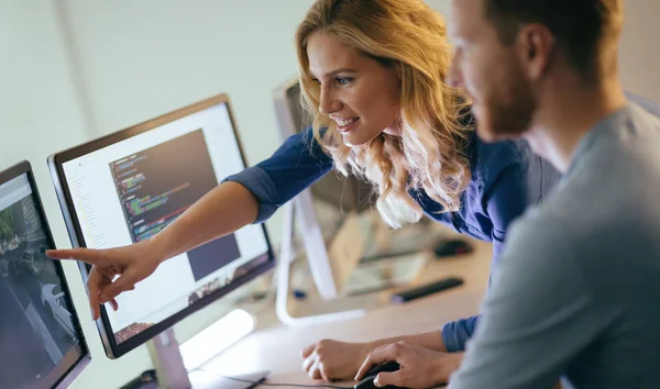 Programmers cooperating at company — Stock Photo, Image