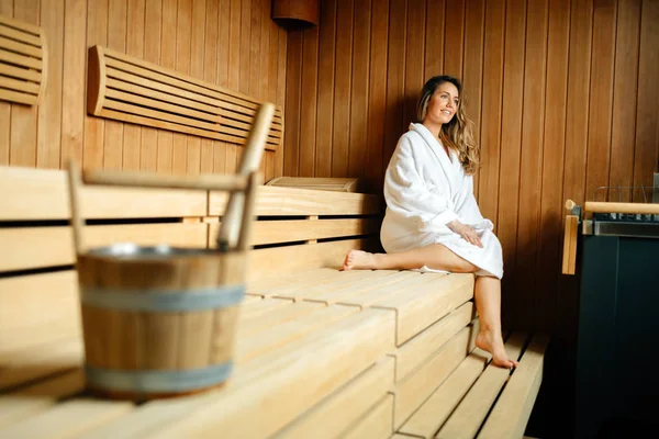 Beautiful woman relaxing in sauna